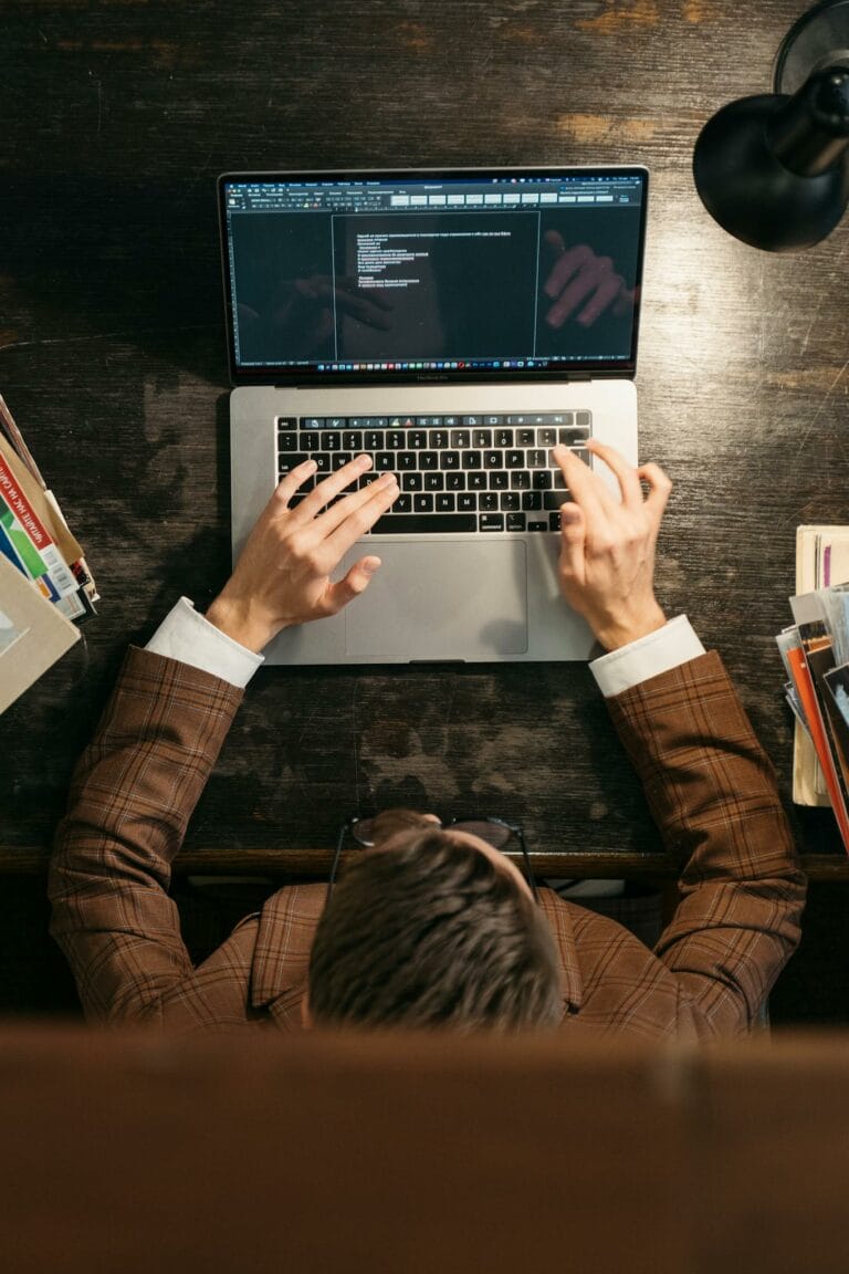 A Person Typing on a Laptop 