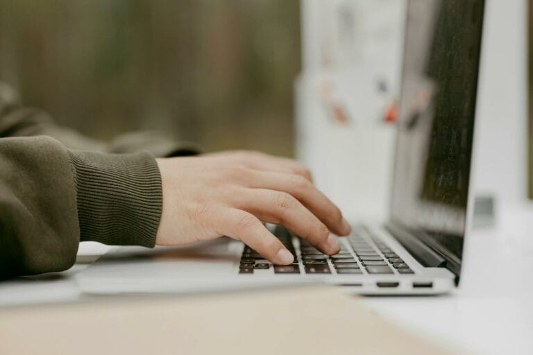 Hands Typing on a Laptop in Close-up Photography